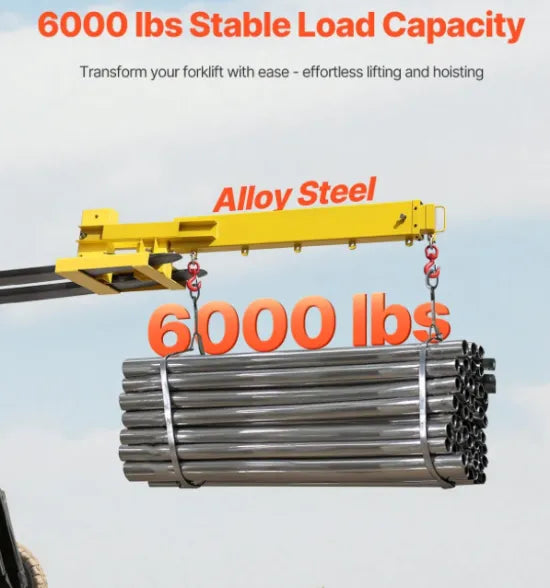 Heavy-duty 6000 lb forklift jib boom crane attachment lifting industrial machinery in a manufacturing facility.